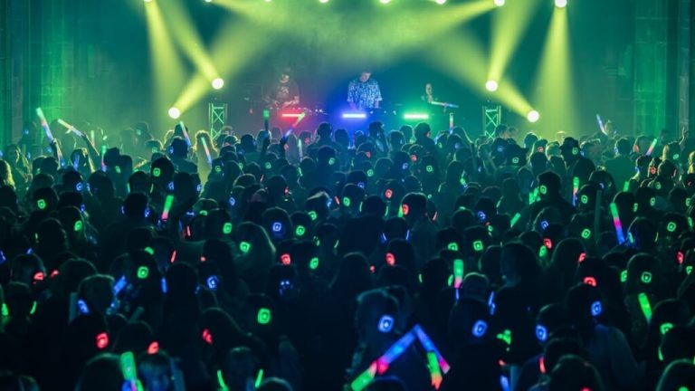 Hundreds of people enjoying a silent disco event with glowing LED headphones - Silent Disco Party UK